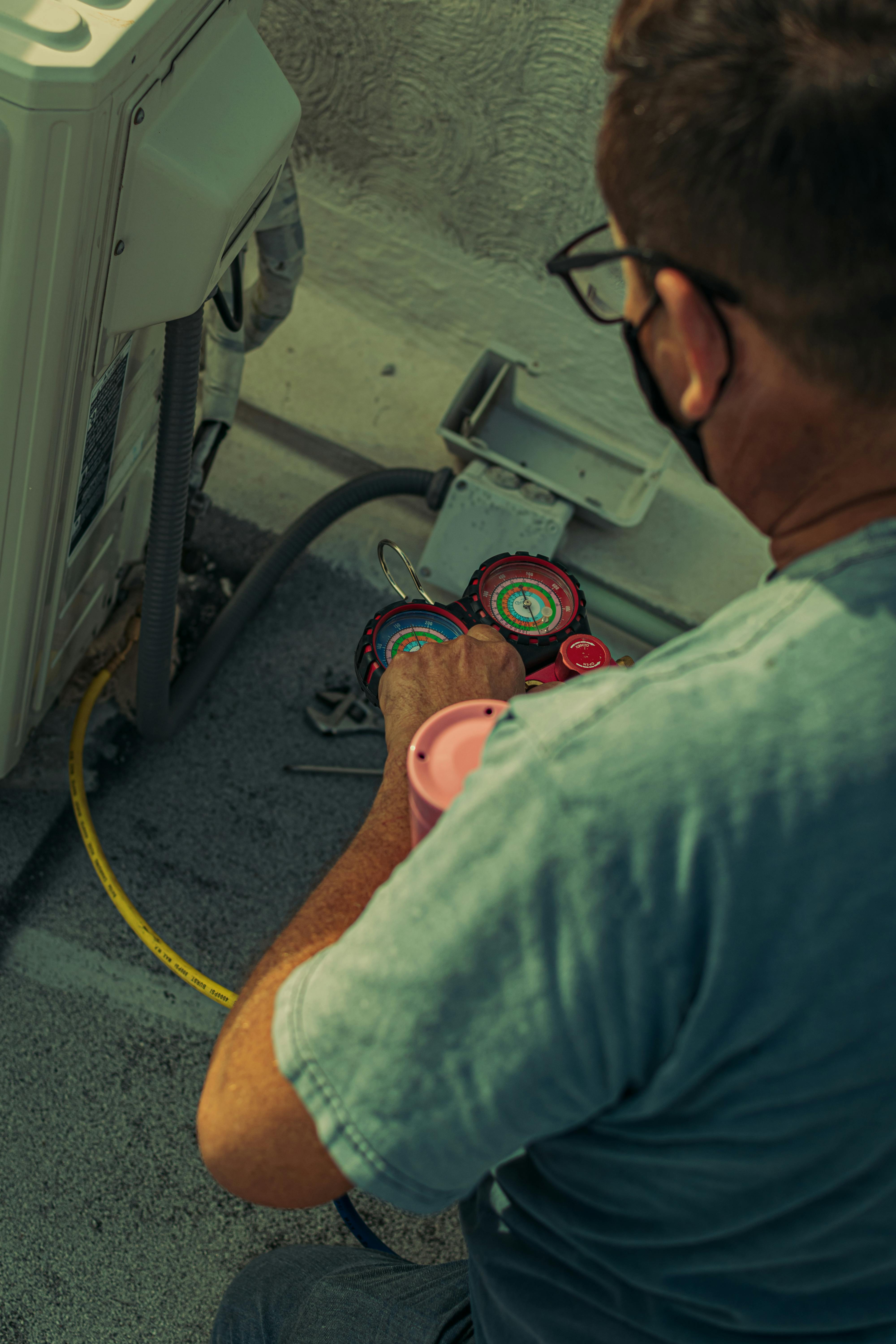 Northwind technician using a manifold gauge during an install